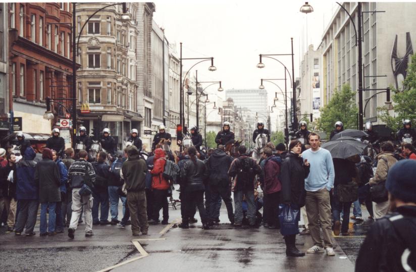 Police horses towering over people in Oxford Circus.