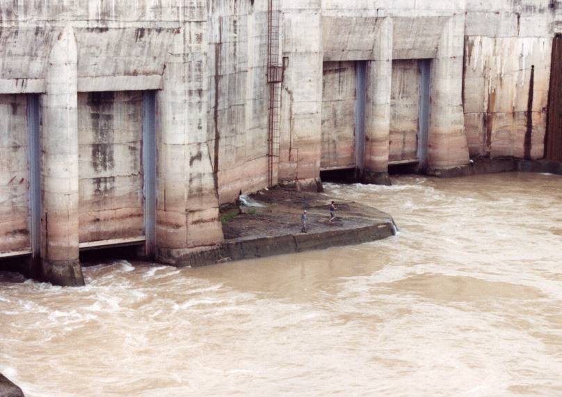 Guys fishing in the water outlet of a massive Soviet hydro dam.